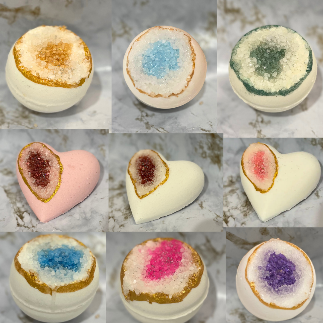 Collage of various bath bombs with different color and texture patterns on a marble surface.