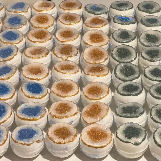 Assorted colored bath bombs on a white background