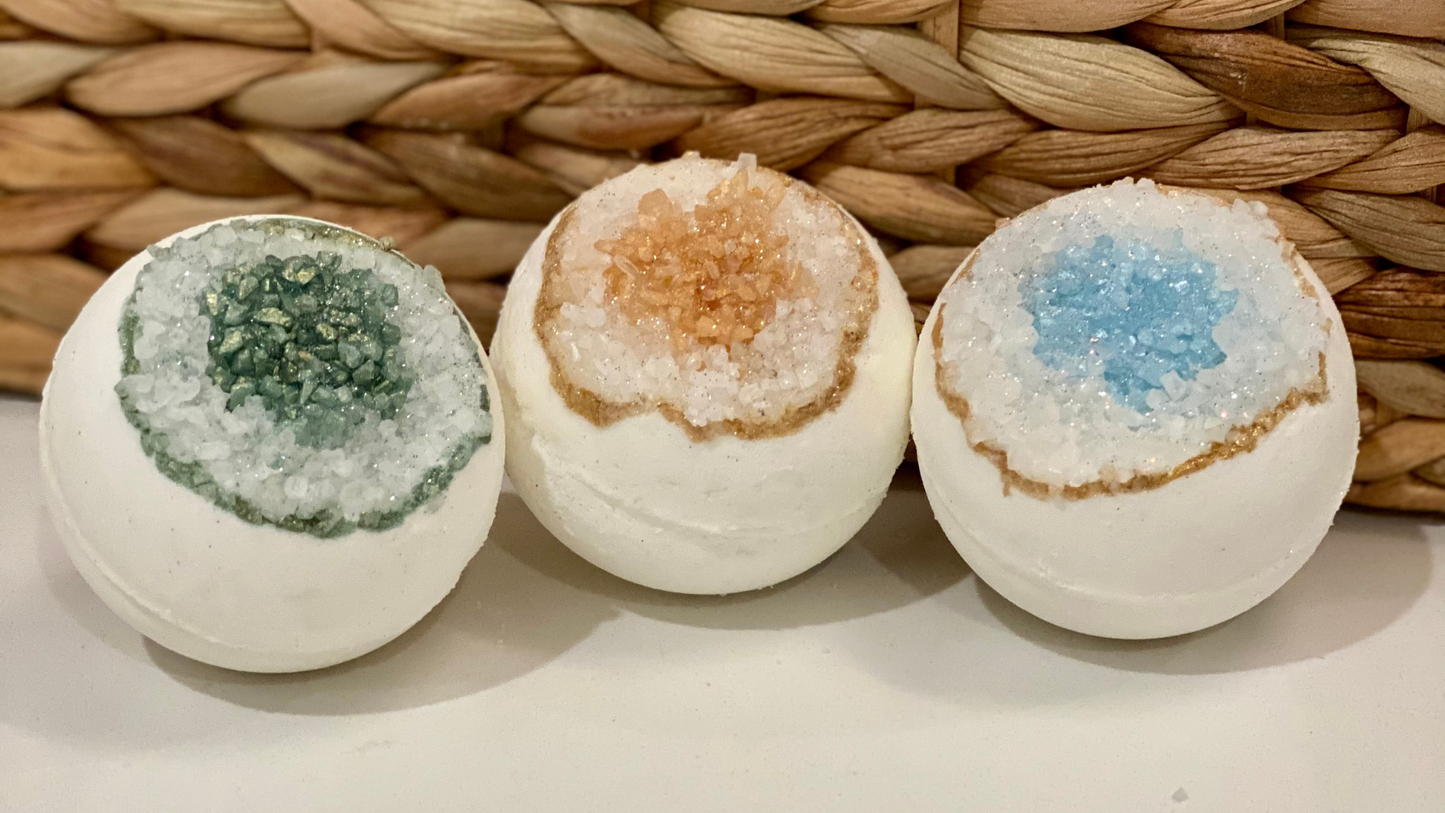 Three colored bath bombs on a woven background
